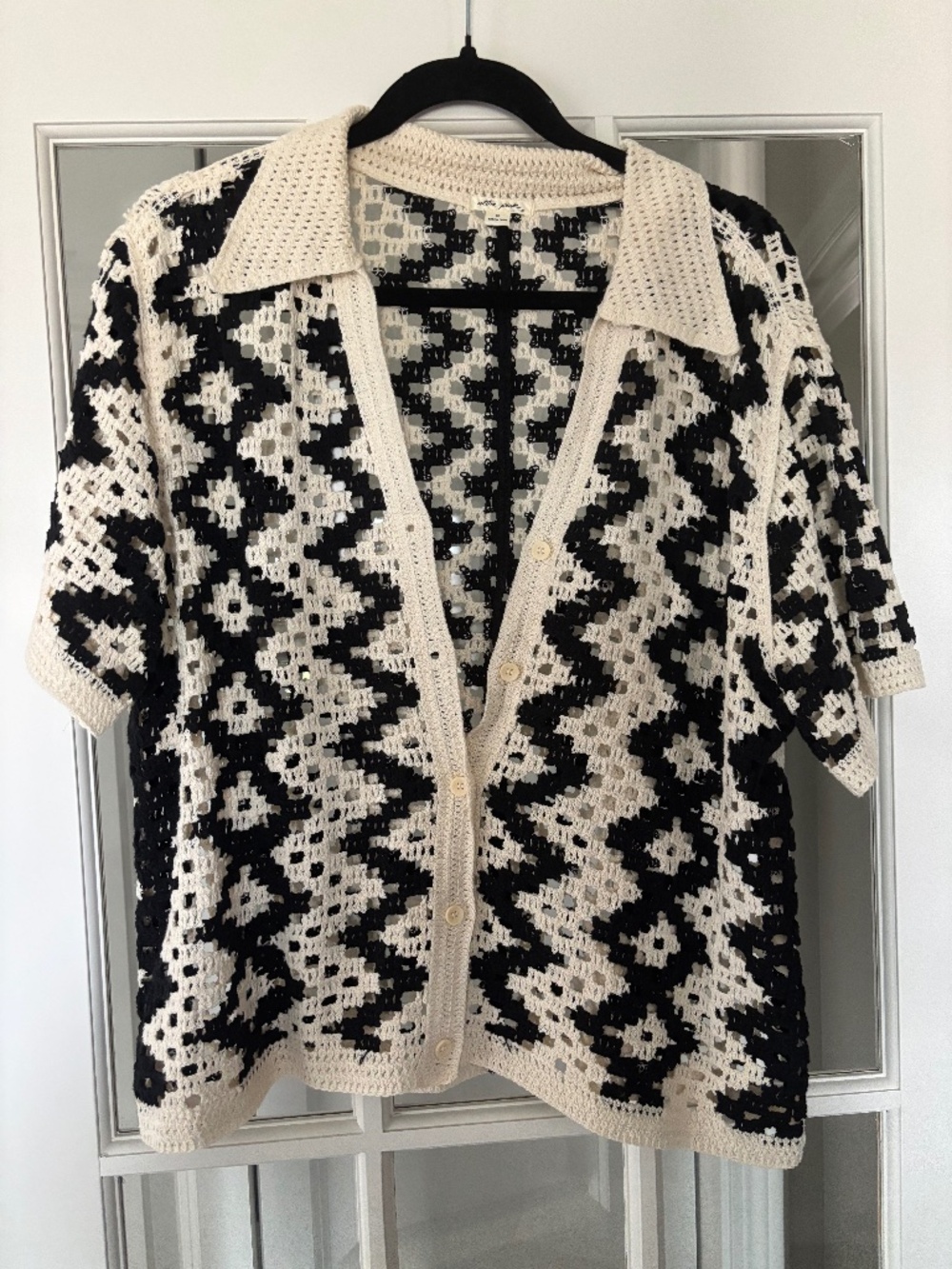 Short sleeved crocheted cardigan.